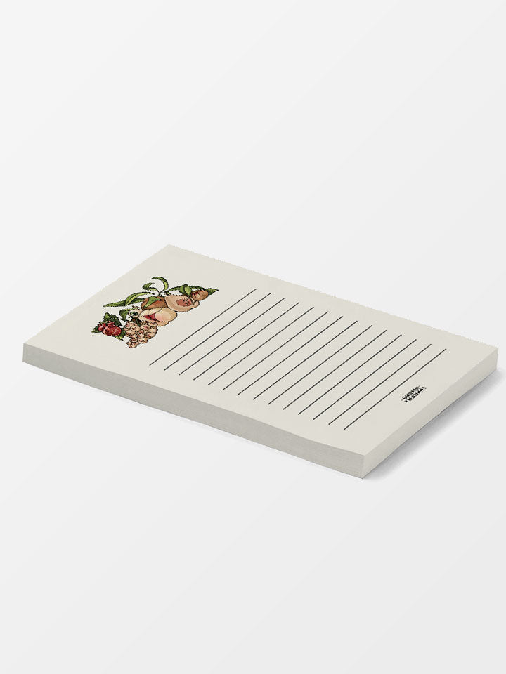 a side view of a unique notepad with a humorous illustration decoration of different fruits as women's body parts, boobs and butts. 